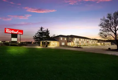 a hotel with a sign in front of a building at Red Roof Inn Lawrenceburg in Lawrenceburg