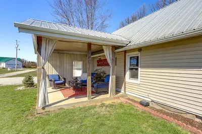 a porch of a house with two chairs on it at Quiet Shiloh Retreat with Spacious Yard and Fireplace! in Shiloh