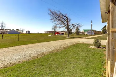 a dirt road next to a house with a tree at Quiet Shiloh Retreat with Spacious Yard and Fireplace! in Shiloh