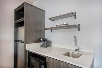 a kitchen with a sink and a microwave at Studio 6 Georgetown KY Lexington North in Georgetown