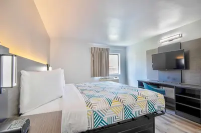 a hotel room with a bed and a desk at Studio 6 Georgetown KY Lexington North in Georgetown