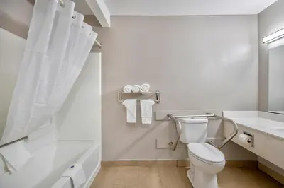 a white bathroom with a toilet and a sink at Studio 6 Georgetown KY Lexington North in Georgetown