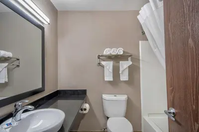 a bathroom with a white toilet and a sink at Studio 6 Georgetown KY Lexington North in Georgetown
