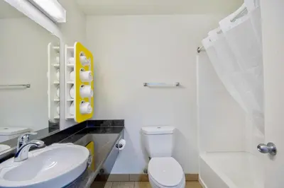 a white bathroom with a sink and a toilet at Studio 6 Georgetown KY Lexington North in Georgetown