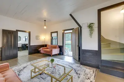 a living room with a couch and a table at Quaint Winesburg Cottage with Porch and Pond! in Dundee