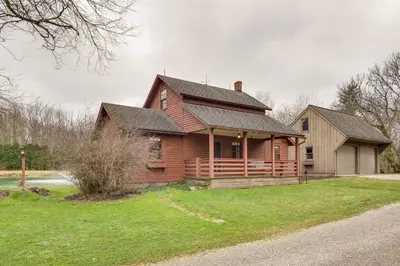 a wooden house with a gambrel roof at Quaint Winesburg Cottage with Porch and Pond! in Dundee