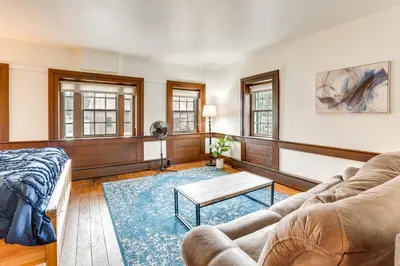 a living room with a couch and a table at Timeless Winesburg Farmhouse with Deck in Dundee