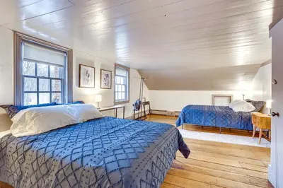 a bedroom with two beds and a window at Timeless Winesburg Farmhouse with Deck in Dundee
