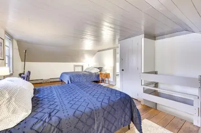 a bedroom with a blue bed in a room at Timeless Winesburg Farmhouse with Deck in Dundee