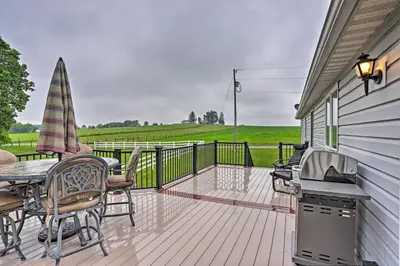 a deck with a table and chairs and a grill at Millersburg Home with Covered Porch and Fire Pit! in Millersburg