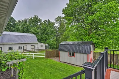 a backyard with a barn and a white fence at Millersburg Home with Covered Porch and Fire Pit! in Millersburg