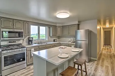a kitchen with a stainless steel refrigerator and a table at Millersburg Home with Covered Porch and Fire Pit! in Millersburg