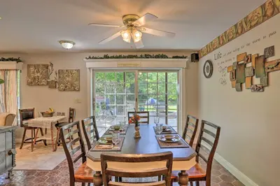 a dining room with a table with chairs and a ceiling fan at Southeast Michigan Escape about 3 Mi to Adrian! in Adrian