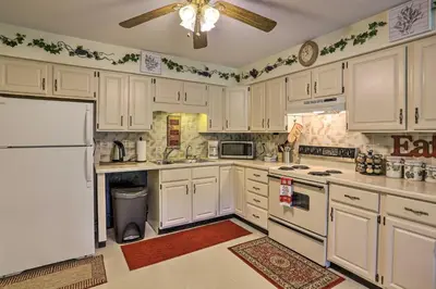a kitchen with white cabinets and a ceiling fan at Southeast Michigan Escape about 3 Mi to Adrian! in Adrian