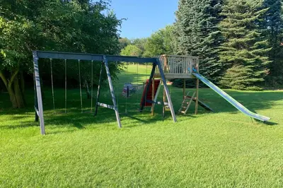 a playground with a slide in the grass at Southeast Michigan Escape about 3 Mi to Adrian! in Adrian