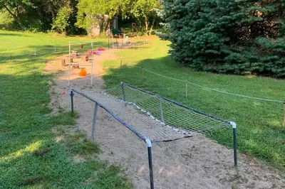a chain link fence in a park with a playground at Southeast Michigan Escape about 3 Mi to Adrian! in Adrian