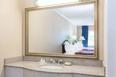 a bathroom with a sink and a mirror at The Inn At Plantation in Weston