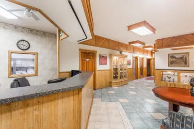 a view of a waiting room with wood paneling at The Inn At Plantation in Weston