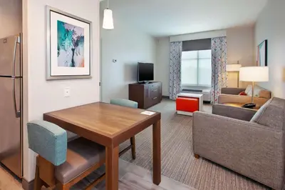 a living room with a table and a room with a couch at Homewood Suites By Hilton Columbus Easton, Oh in Columbus