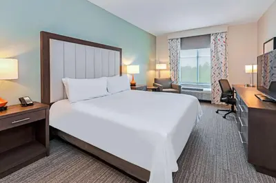 a bedroom with a large bed and a desk and a television at Homewood Suites By Hilton Columbus Easton, Oh in Columbus