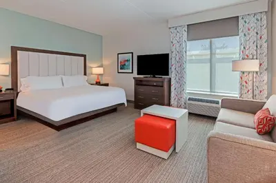 a large hotel room with a bed and a couch at Homewood Suites By Hilton Columbus Easton, Oh in Columbus
