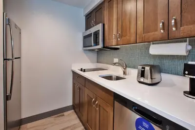 a kitchen with a sink and a refrigerator at Homewood Suites By Hilton Columbus Easton, Oh in Columbus