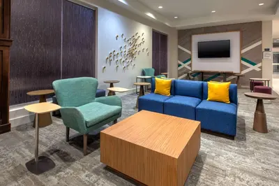 a lobby with a couch and chairs and a tv at Hilton Garden Inn Columbus Easton, Oh in Columbus