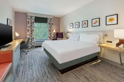 a hotel room with a large bed and a flat screen tv at Hilton Garden Inn Columbus Easton, Oh in Columbus