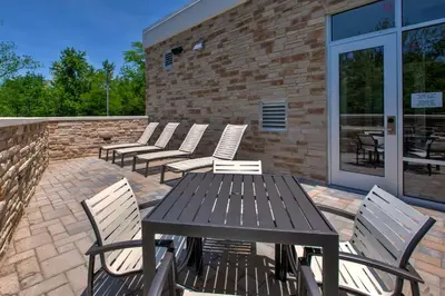 a wooden table and chairs on a patio at Hilton Garden Inn Columbus Easton, Oh in Columbus