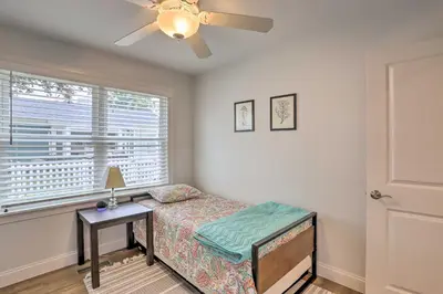 a bedroom with a bed and a table and a window at Port Clinton Home with Lake Views! in Port Clinton