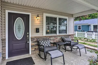 a front door of a house with chairs and a table at Port Clinton Home with Lake Views! in Port Clinton
