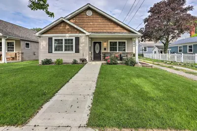 a house with a grass yard with a driveway at Port Clinton Home with Lake Views! in Port Clinton