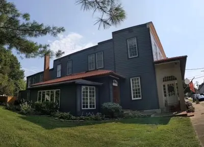 a large black house with at The Benchmark Inn in Augusta