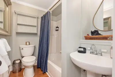 a bathroom with a white toilet and a sink at The Benchmark Inn in Augusta