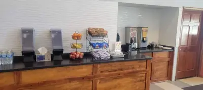 a kitchen with a counter with food on it at Royal Inn & Suites in Akron
