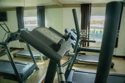 a gym with several treadmills and machines at Royal Inn & Suites in Akron