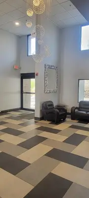 a lobby with a checkered floor and chandeliers at Royal Inn & Suites in Akron