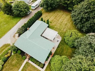 an overhead view of a house with a blue roof at 3 Bedroom home outside of Berlin, Patio with Hot Tub! in Millersburg