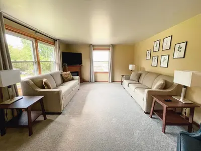 a living room with couches and a flat screen tv at 3 Bedroom home outside of Berlin, Patio with Hot Tub! in Millersburg