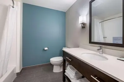 a bathroom with a sink and a toilet and a mirror at Sleep Inn in Georgetown