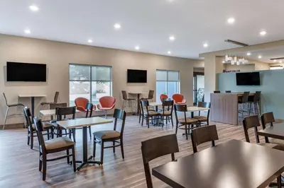 a restaurant with tables and chairs and a bar at Sleep Inn in Georgetown