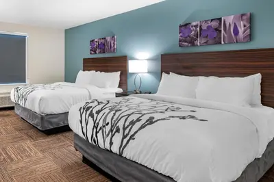 a hotel room with two beds and a window at Sleep Inn in Georgetown