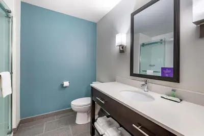 a bathroom with a sink and a toilet at Sleep Inn in Georgetown