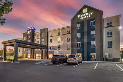 a hotel with cars parked in a parking lot at MainStay Suites Georgetown Lexington North in Georgetown