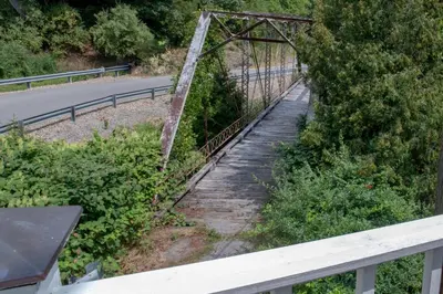 an old rusty bridge over a road at Elk River Hotel in Sutton