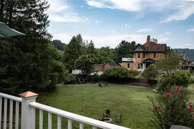 a view of a house with a yard at Elk River Hotel in Sutton