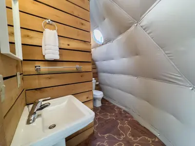 a small bathroom with a sink and a toilet at Elk River Hotel in Sutton
