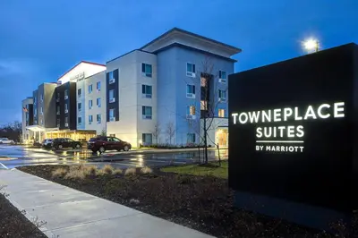 a sign in front of a building with a hotel at TownePlace Suites by Marriott Monroe in Monroe