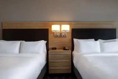 two beds sitting next to each other in a hotel room at TownePlace Suites by Marriott Monroe in Monroe
