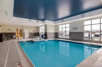 a swimming pool with blue water in a building at TownePlace Suites by Marriott Monroe in Monroe